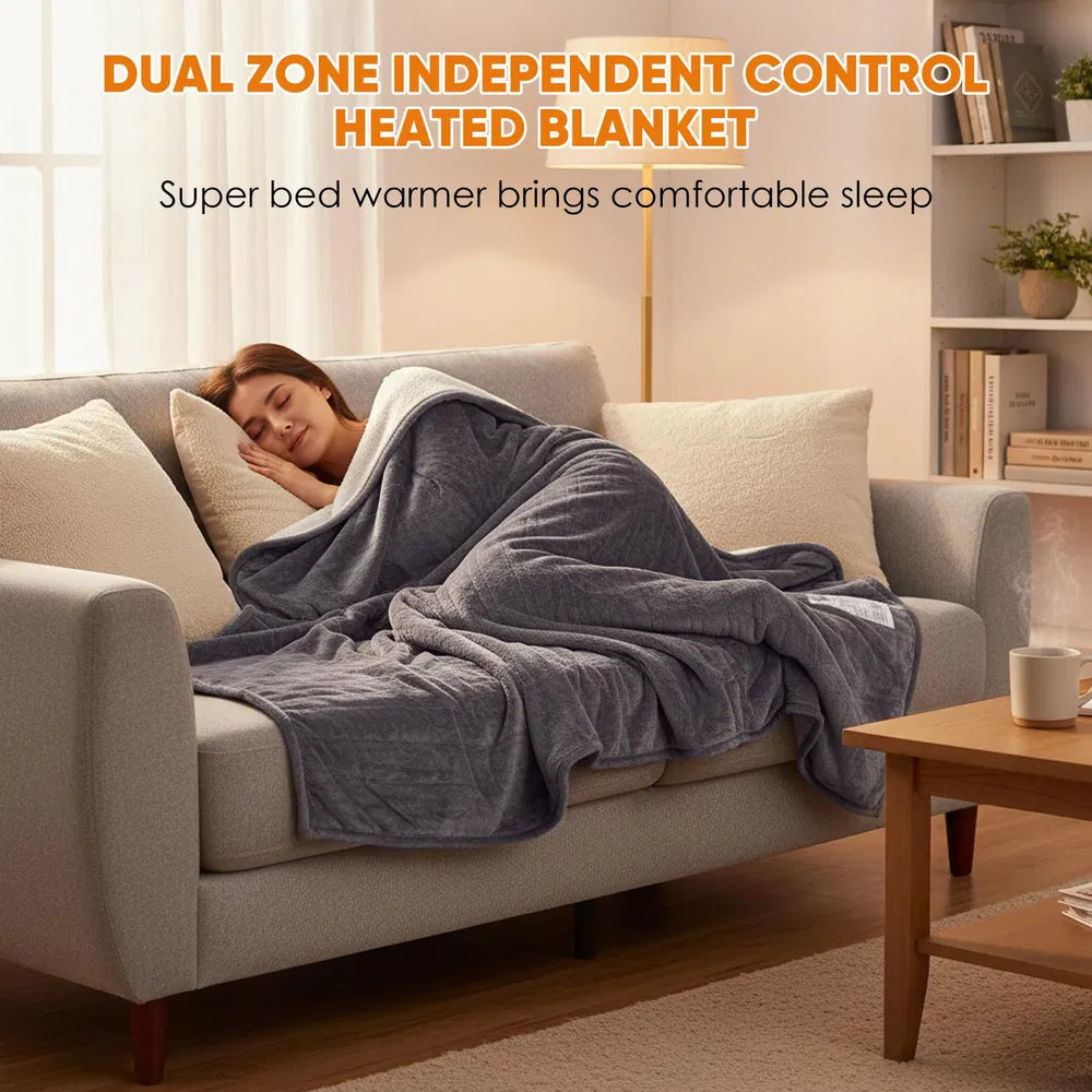 Woman sleeping soundly on a sofa, covered by a gray dual-zone flannel and Sherpa heated blanket.