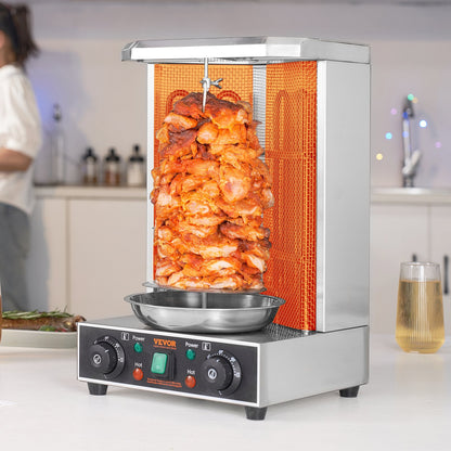 Silver stainless steel vertical broiler with a large rotating skewer of cooking chicken shawarma.