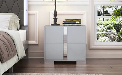 Gray nightstand with mirrored panels, two drawers, and sleek metal feet.