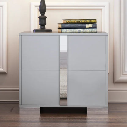 Gray nightstand with mirrored panels, two drawers, and sleek metal feet.