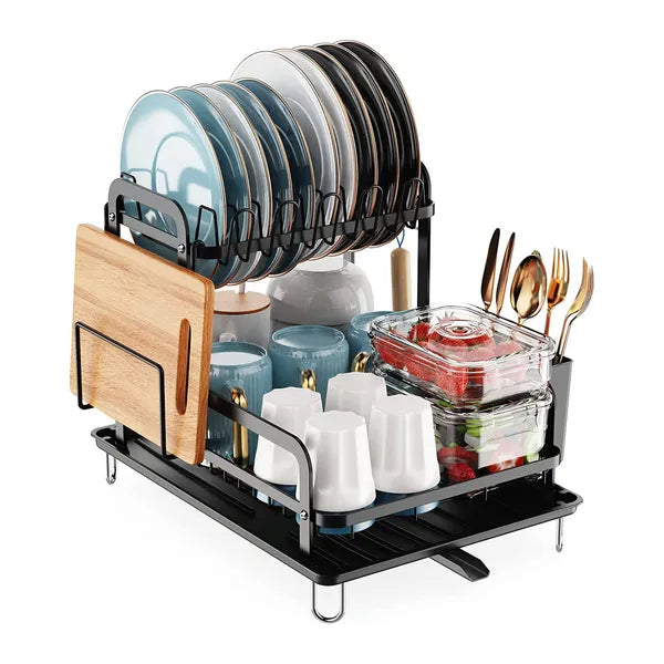 Black 2-tier dish drying rack with drainboard, holding plates, cups, utensils, and a cutting board.