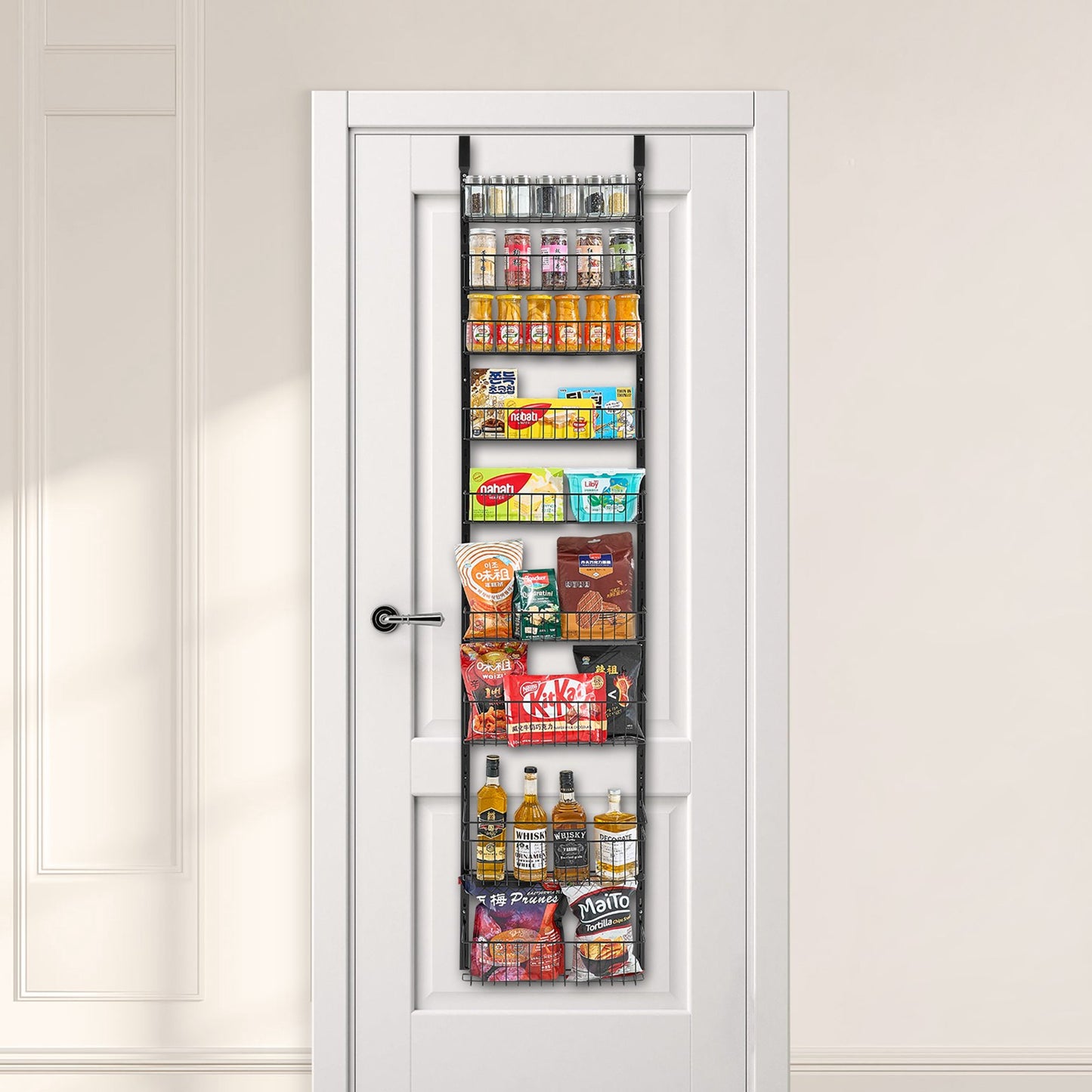 Black 9-tier heavy-duty over-door organizer filled with various pantry items on a white door.