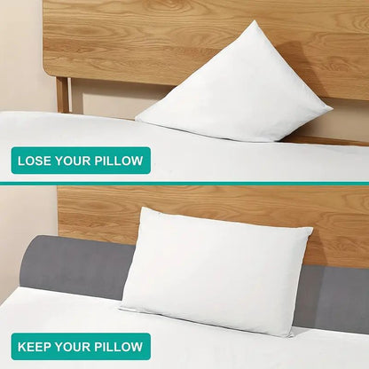 Gray ergonomic bed gap pillow preventing a white pillow from falling between mattress and wooden headboard.