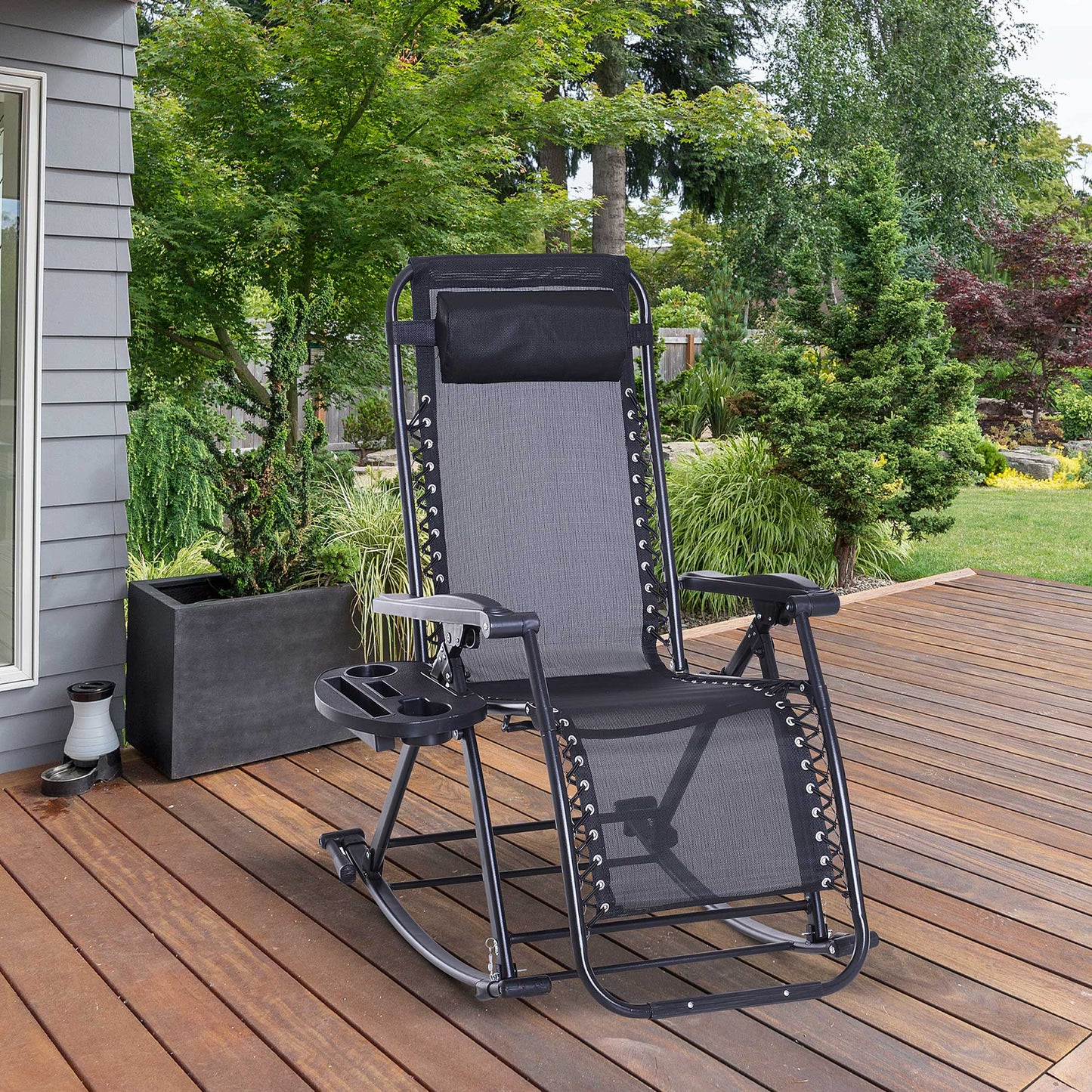 Black zero gravity rocking chair with mesh fabric, padded headrest, and side cup/phone holder on a wooden deck.