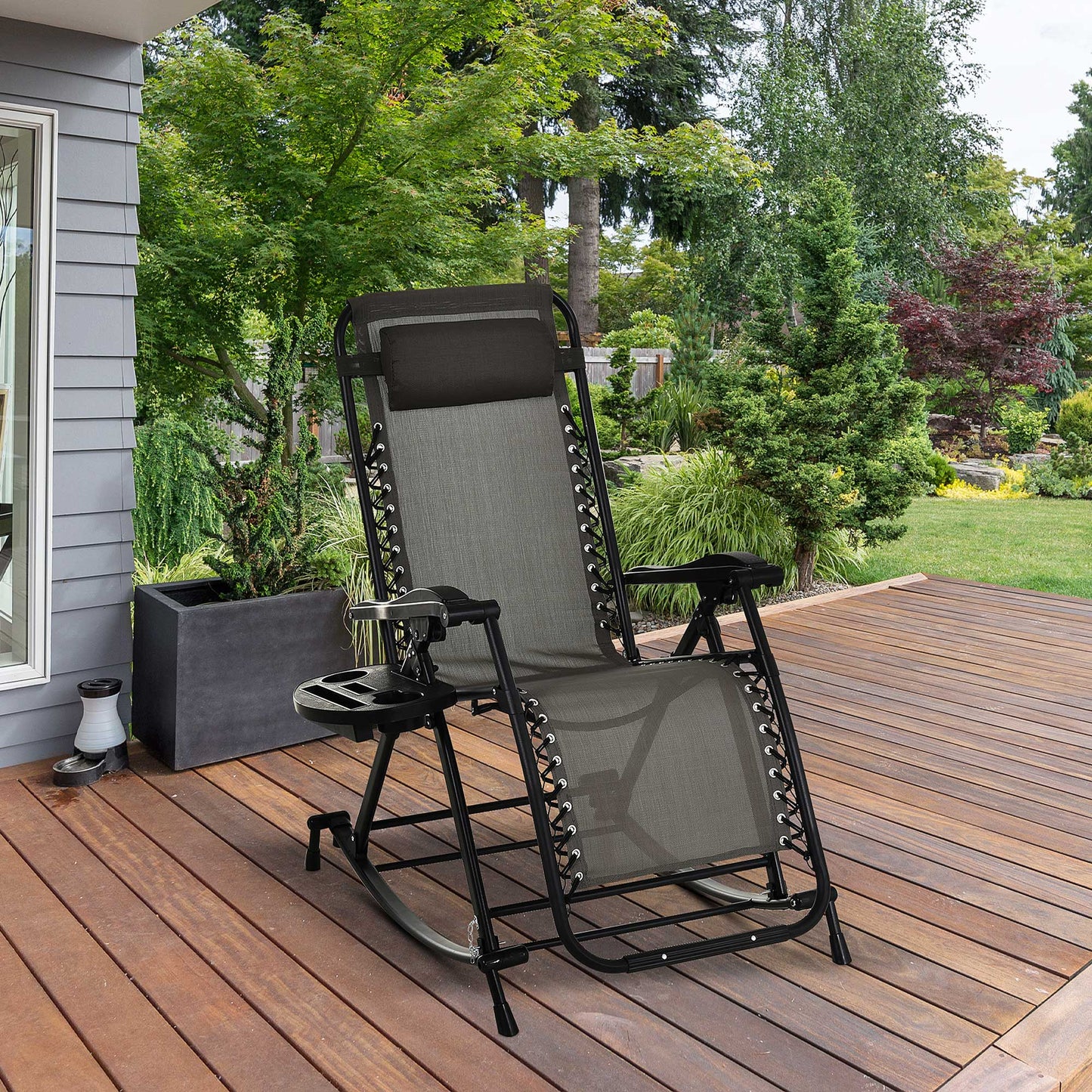 Steel gray zero gravity rocking chair with black frame and integrated side tray on a wooden deck.