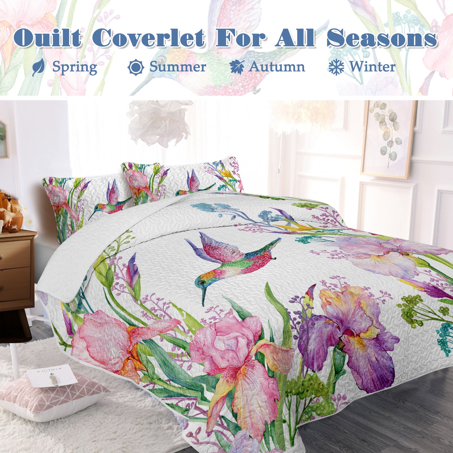 White watercolor hummingbird and floral quilt set with two matching shams on a bed.