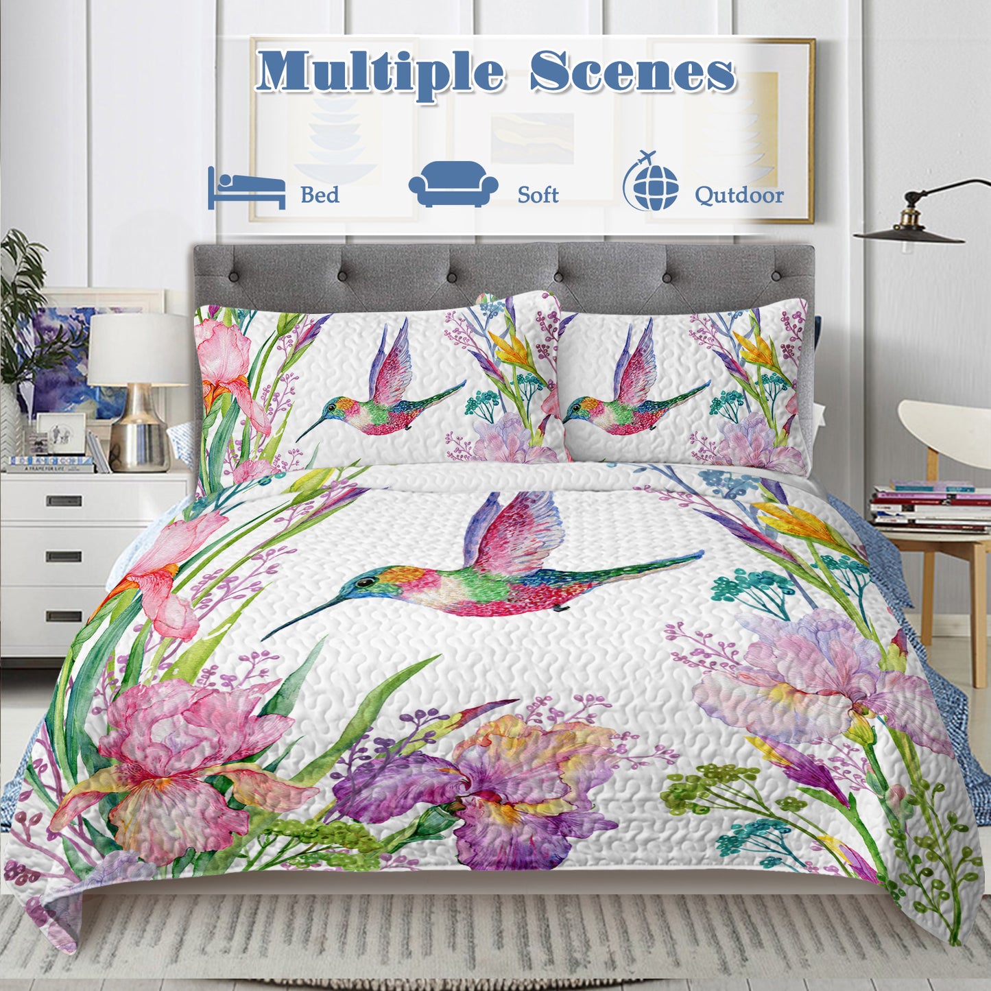 White watercolor hummingbird and floral quilt set with two matching shams on a bed.