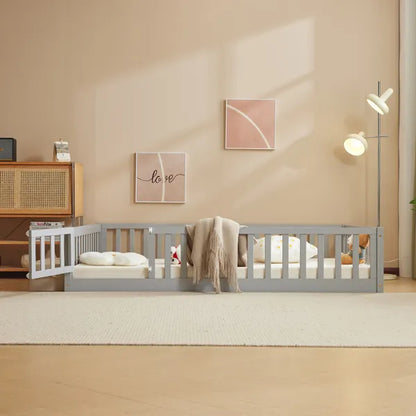 Gray pine wood full-size playpen bed with secure entry door, mattress, and bedding in a child's room.