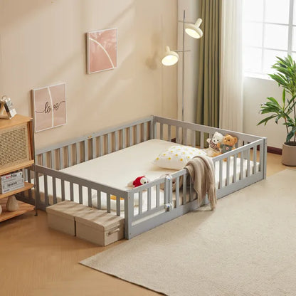Gray pine wood full-size playpen bed with secure entry door, mattress, and two storage bins.