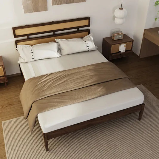 Dark walnut solid pine bed with double-woven rattan headboard, white bedding, and a brown throw.