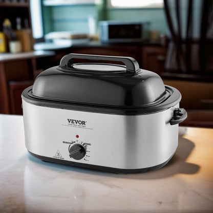 Silver 24QT VEVOR electric roaster oven with black lid and temperature dial on a kitchen counter.