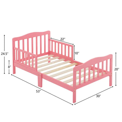 Pink wooden toddler bed with vertical plank headboard, side rails, and slatted base.