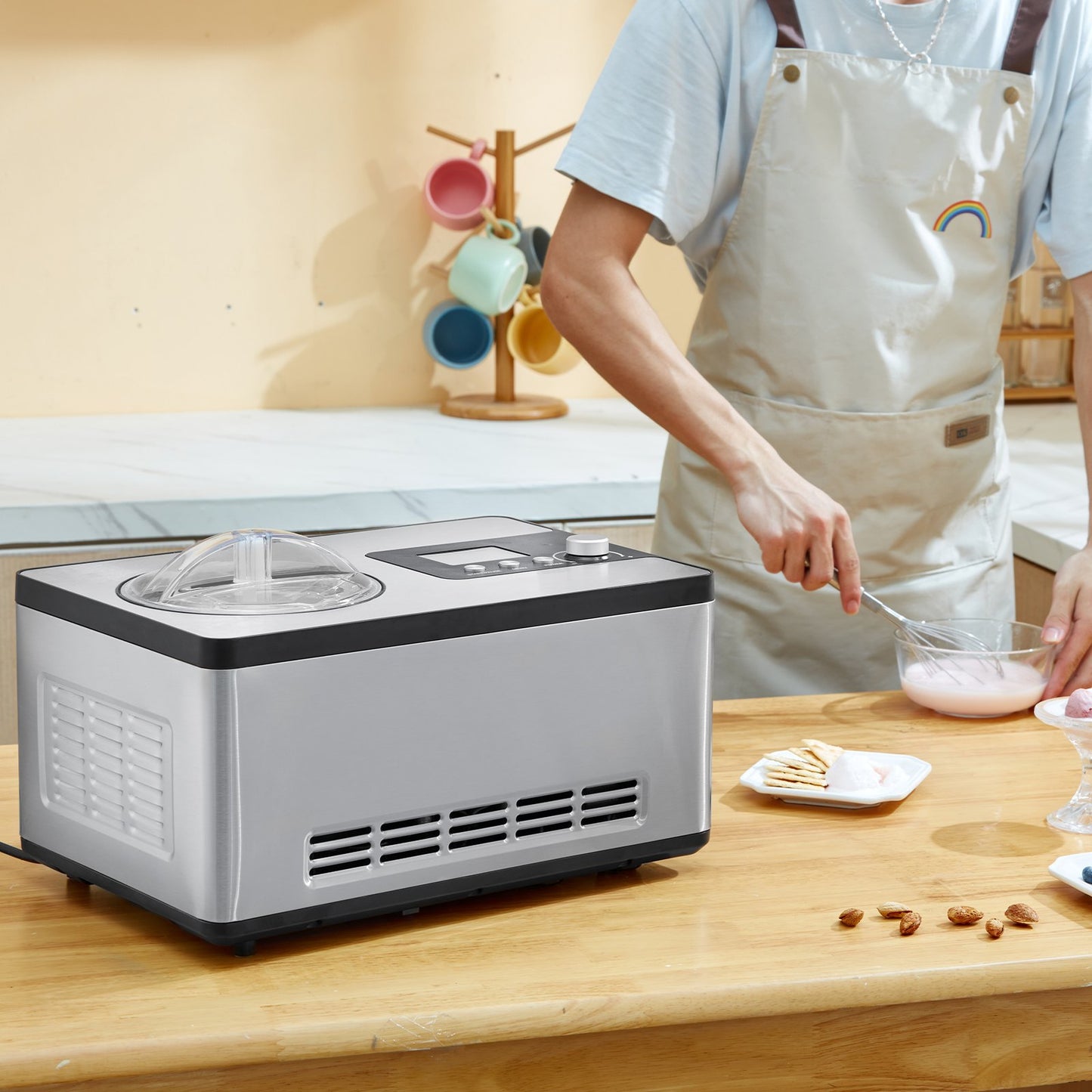 Sleek stainless-steel Gelato Gourmet 2-quart compressor ice cream maker on a wooden counter.
