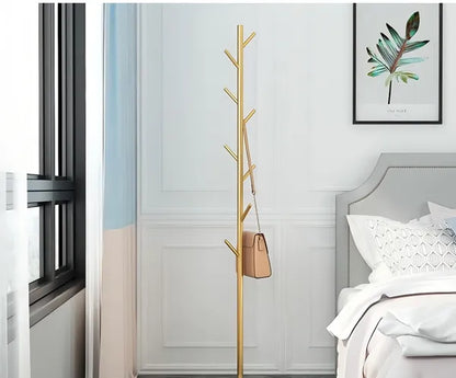 The Golden Aura luxury garment rack with a gold metal frame and faux marble base, holding a brown purse.