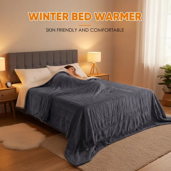 A woman sleeps soundly under a dark gray flannel and Sherpa dual-zone electric blanket on a bed.