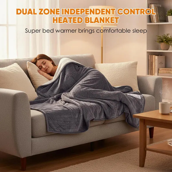 Woman sleeping soundly on a sofa, covered by a gray flannel and Sherpa dual-zone heated blanket.
