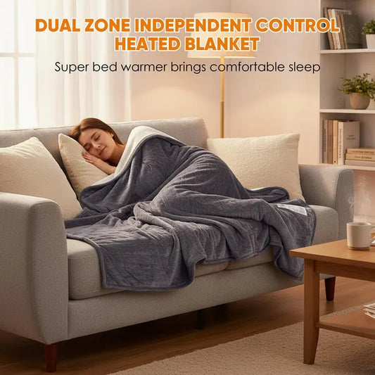 Woman sleeping soundly on a sofa, covered by a gray flannel and Sherpa dual-zone heated blanket.