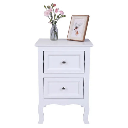 White "Heritage Charm" 2-tier nightstand with two drawers, a vase of flowers, and a framed picture.