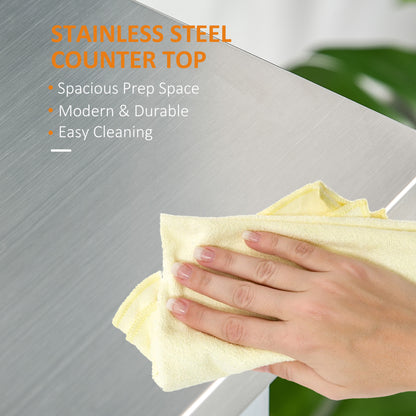 Hand wiping a sleek, silver stainless steel kitchen island countertop, highlighting its easy-clean surface.