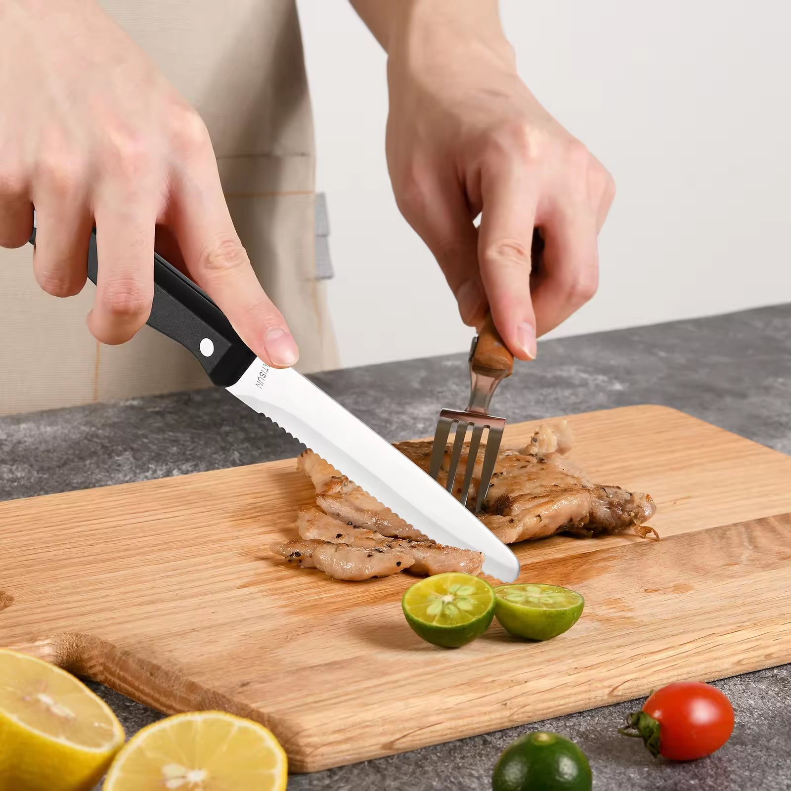 Person slicing grilled meat with a black-handled serrated stainless steel knife on a wooden cutting board.