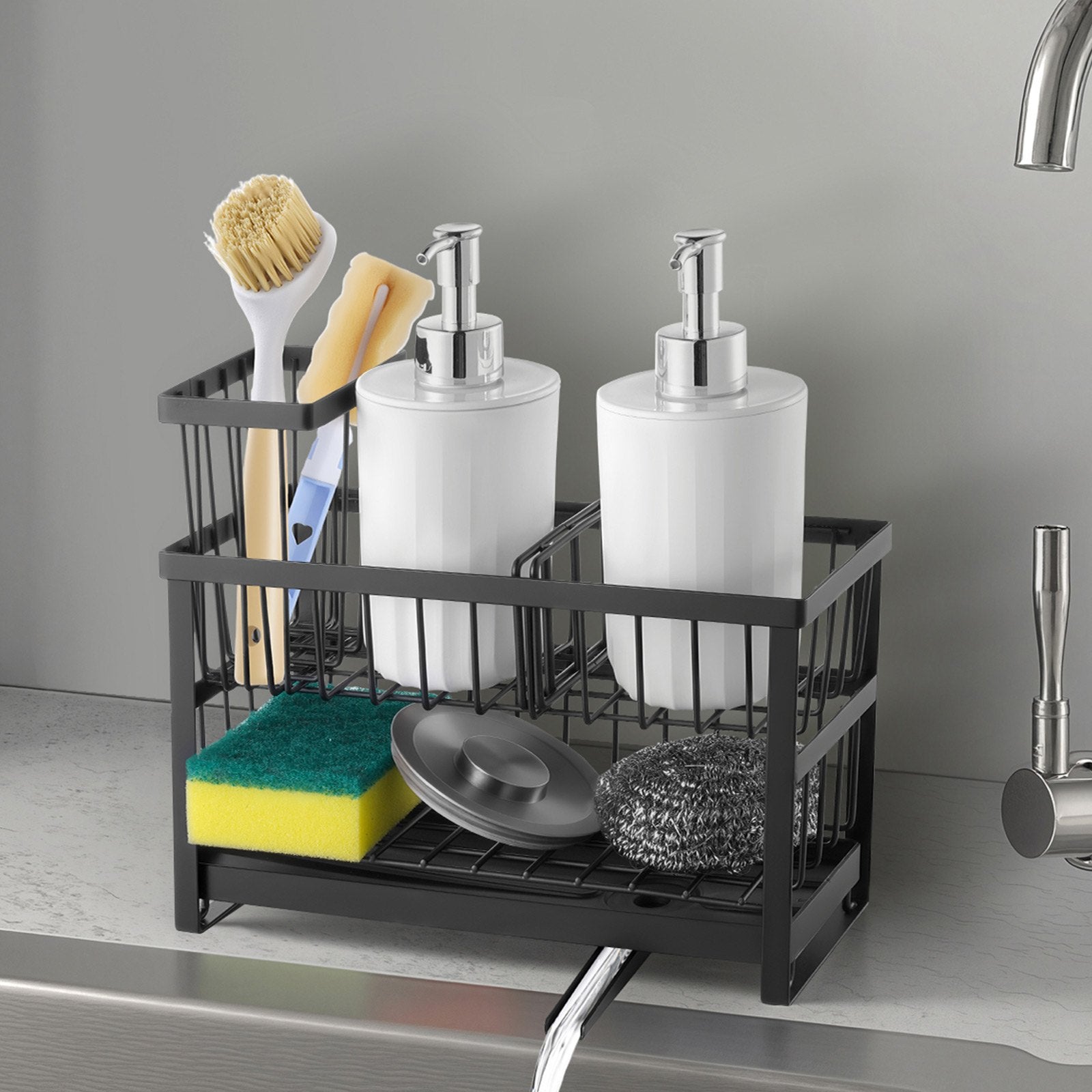 Black metal sink caddy with two white soap dispensers, sponges, and brushes.