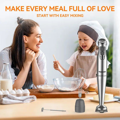 Silver stainless steel immersion blender with whisk and milk frother attachments on a kitchen counter.