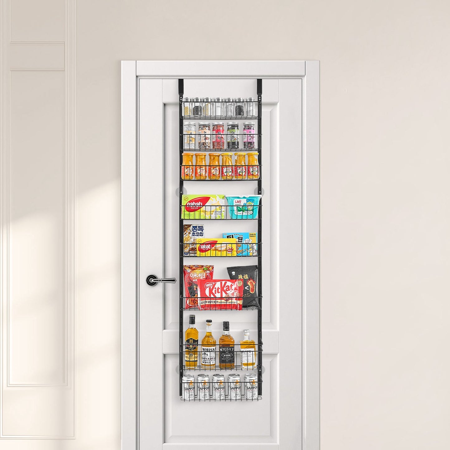 Black 8-tier metal over-door organizer with adjustable baskets, filled with pantry items on a white door.