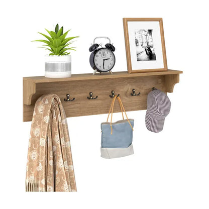 Natural wood wall-mounted coat rack with 6 black hooks, a storage shelf, and decorative items.