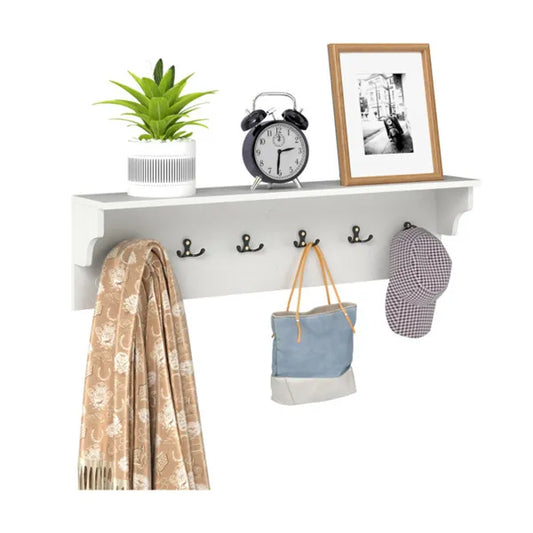 White entryway shelf with six black hooks, a top shelf, a plant, alarm clock, framed photo, scarf, bag, and hat.
